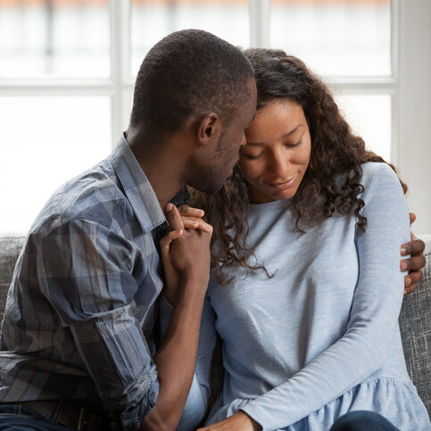 Caring black engaged couple hugs, having a tender close moment, enjoying time together